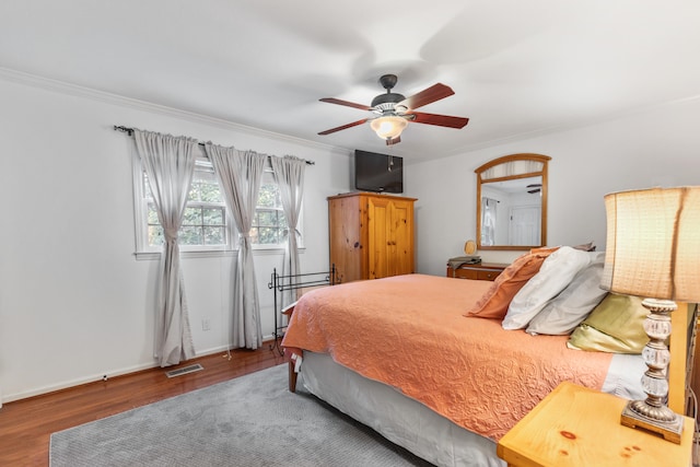 bedroom featuring ceiling fan, crown molding, wood-type flooring, and pool table