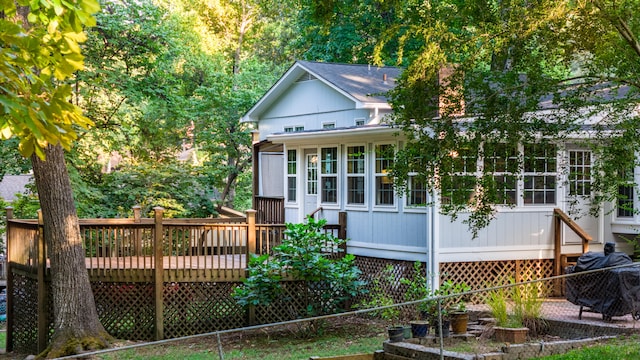 rear view of property featuring a wooden deck