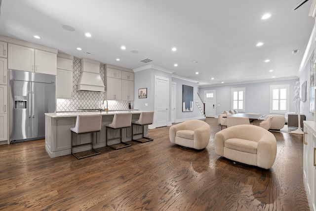 living room featuring dark hardwood / wood-style flooring and ornamental molding