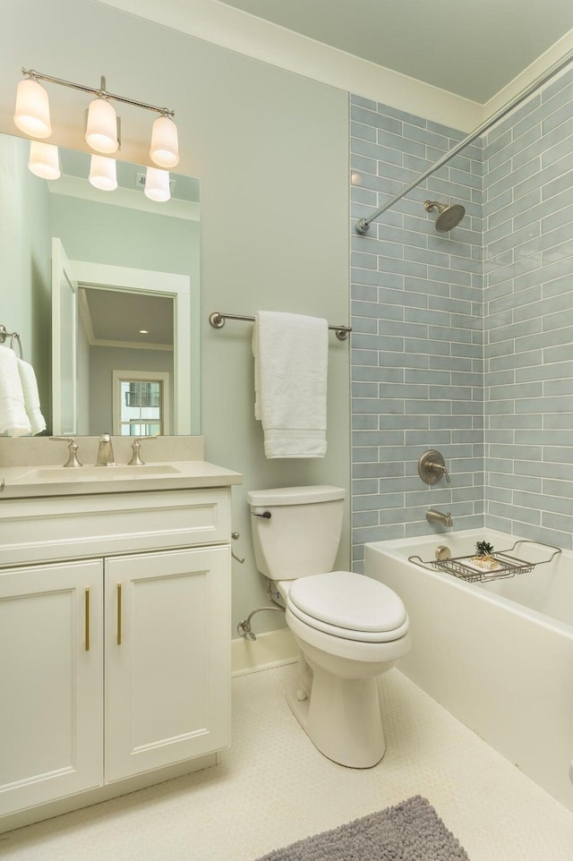 full bathroom with vanity, tiled shower / bath, tile patterned flooring, toilet, and ornamental molding