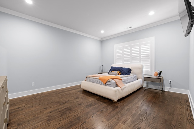 bedroom with dark hardwood / wood-style flooring and crown molding