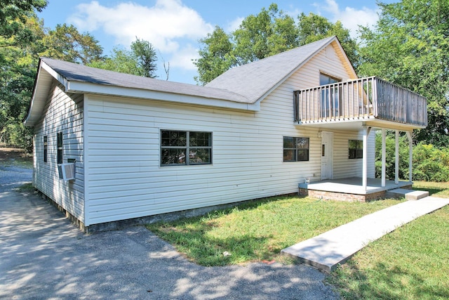 rear view of property with a yard and a patio