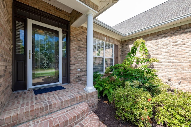 view of exterior entry featuring covered porch