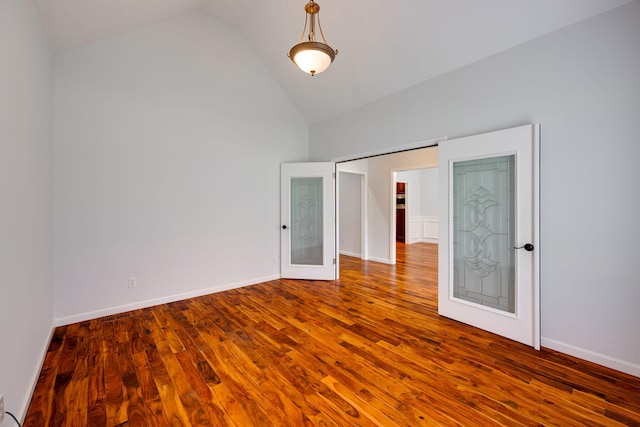 unfurnished bedroom with vaulted ceiling, hardwood / wood-style floors, and a closet