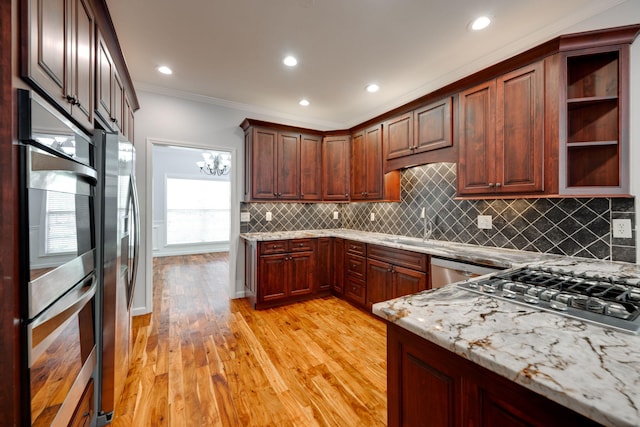 kitchen featuring ornamental molding, tasteful backsplash, light hardwood / wood-style flooring, stainless steel appliances, and light stone countertops