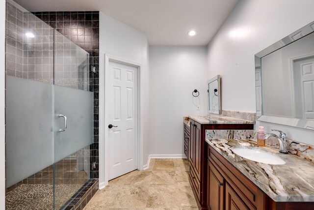 bathroom featuring walk in shower and vanity