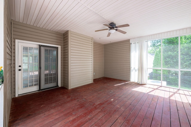 unfurnished sunroom with wood ceiling and ceiling fan