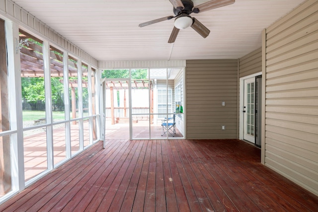 unfurnished sunroom with ceiling fan