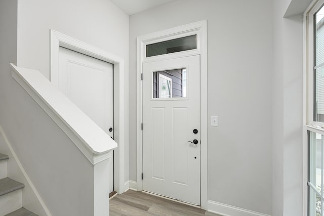 entrance foyer featuring light hardwood / wood-style flooring and a healthy amount of sunlight