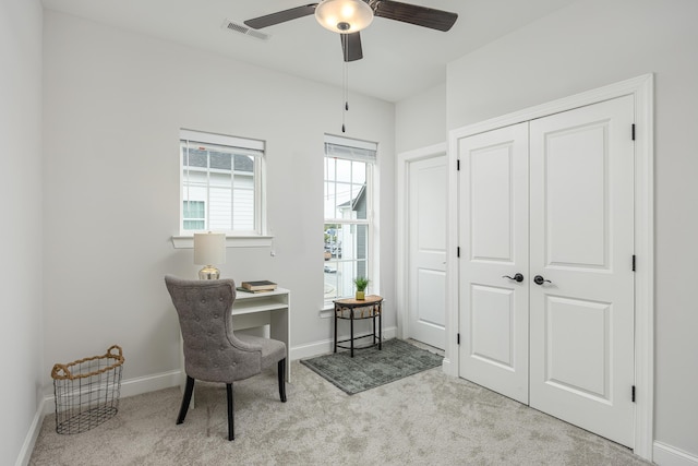 sitting room with ceiling fan and light colored carpet