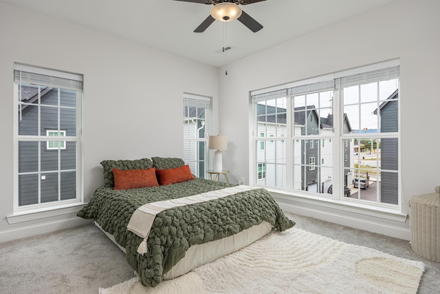 bedroom with ceiling fan and carpet floors