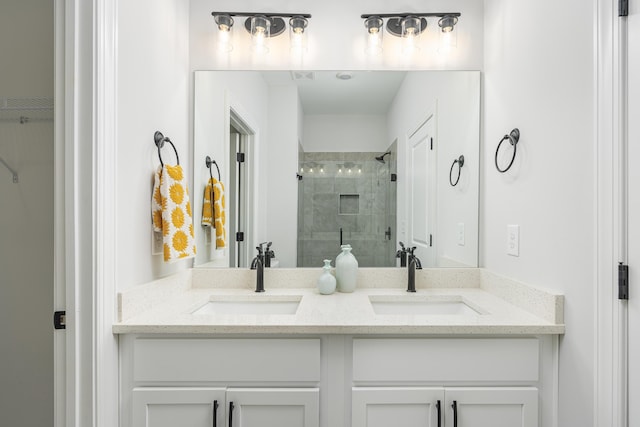 bathroom with vanity and a shower with shower door