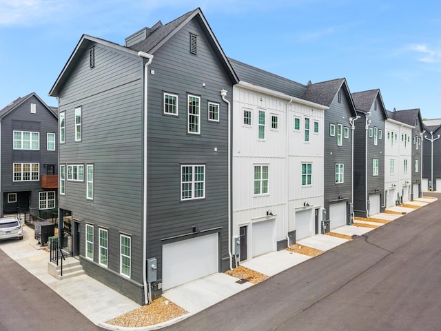 view of home's exterior with a garage and cooling unit