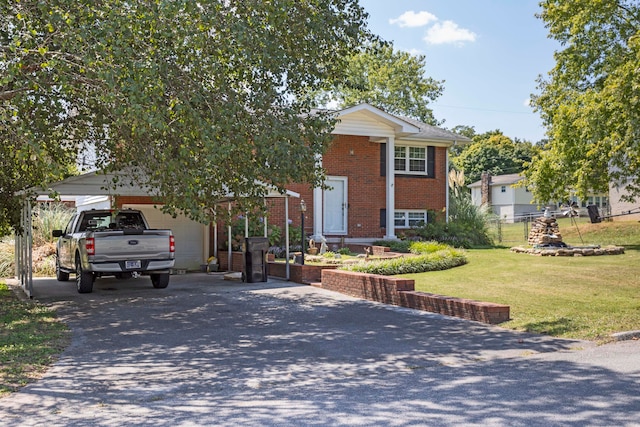 raised ranch with a carport, a garage, and a front lawn