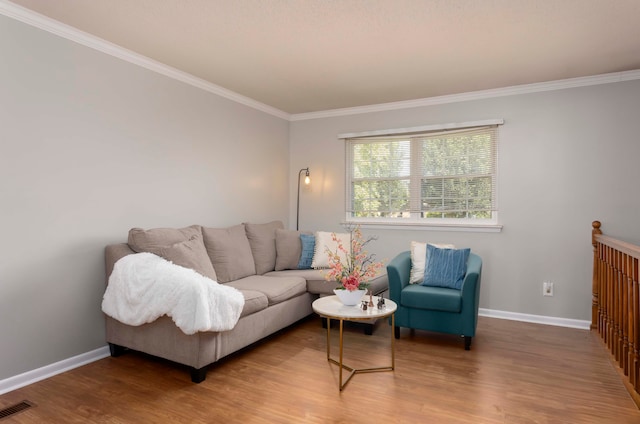 living room featuring wood-type flooring and crown molding