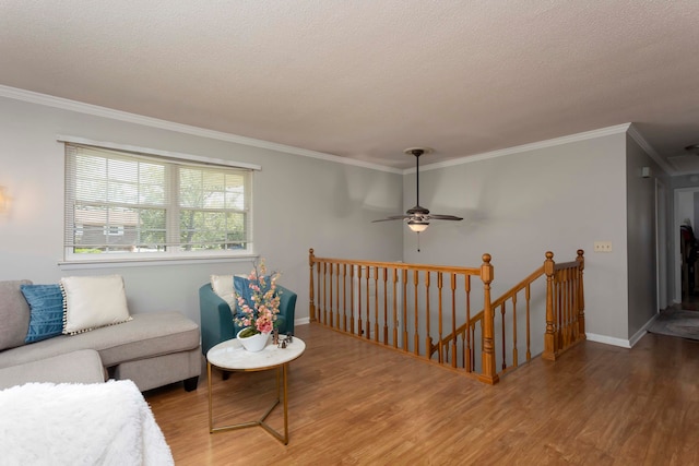 living room with ornamental molding, a textured ceiling, and hardwood / wood-style floors