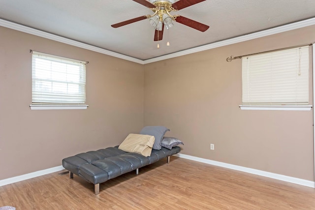 unfurnished room featuring light wood-type flooring, ornamental molding, and ceiling fan