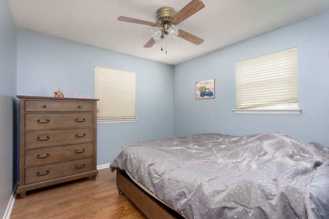 bedroom featuring light hardwood / wood-style flooring and ceiling fan