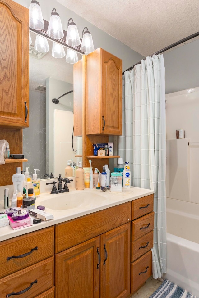 bathroom featuring vanity, shower / tub combo, and a textured ceiling