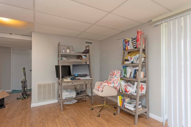 office space featuring light hardwood / wood-style floors and a drop ceiling