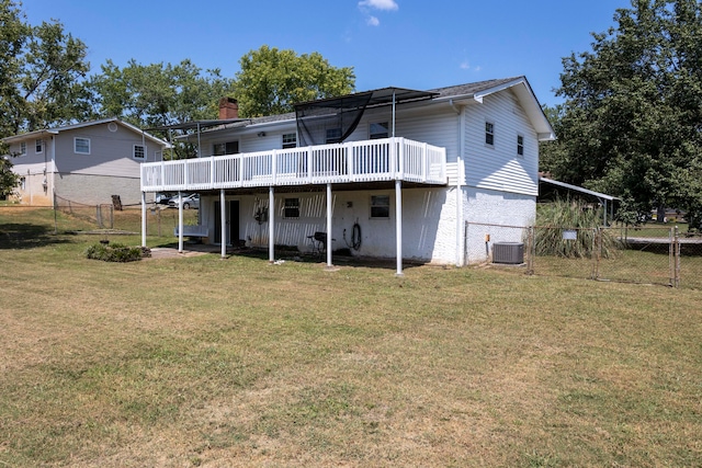 rear view of house with a wooden deck, central AC unit, and a yard