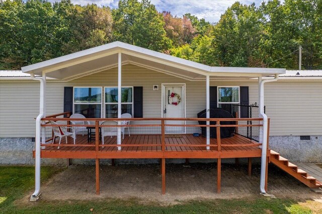 rear view of house featuring a wooden deck