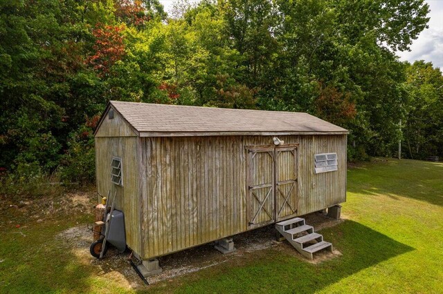 view of outbuilding with a yard