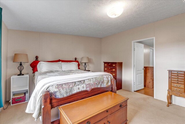 carpeted bedroom with a textured ceiling