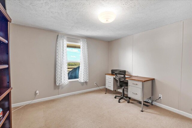 office with light carpet and a textured ceiling