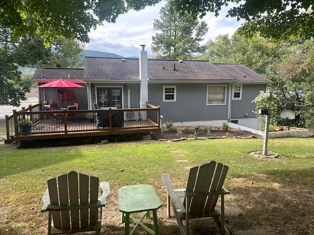 back of house with a wooden deck and a yard