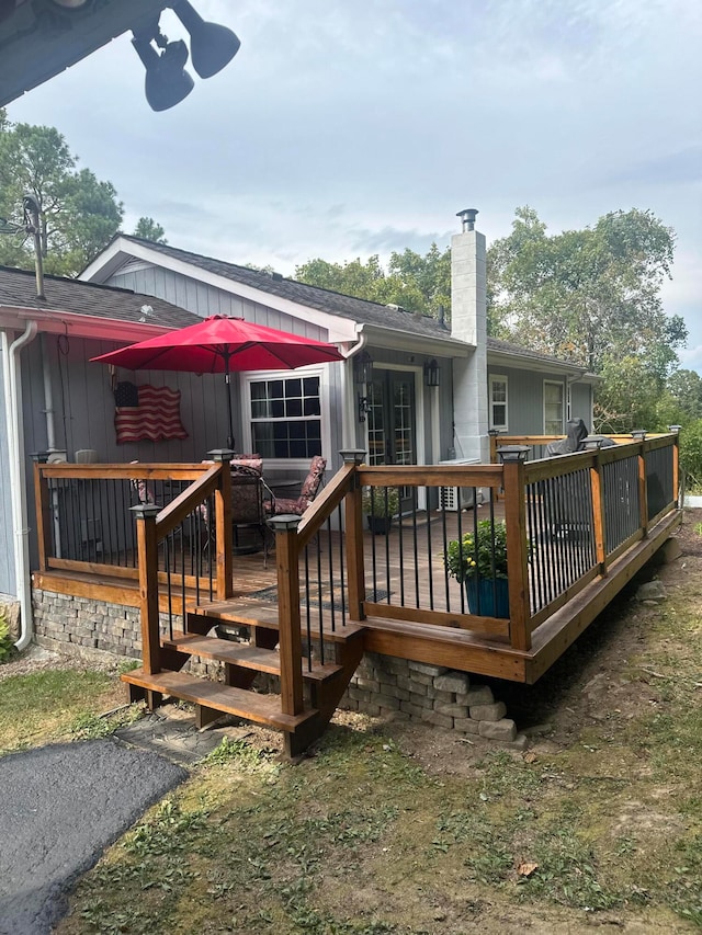 back of house with a deck