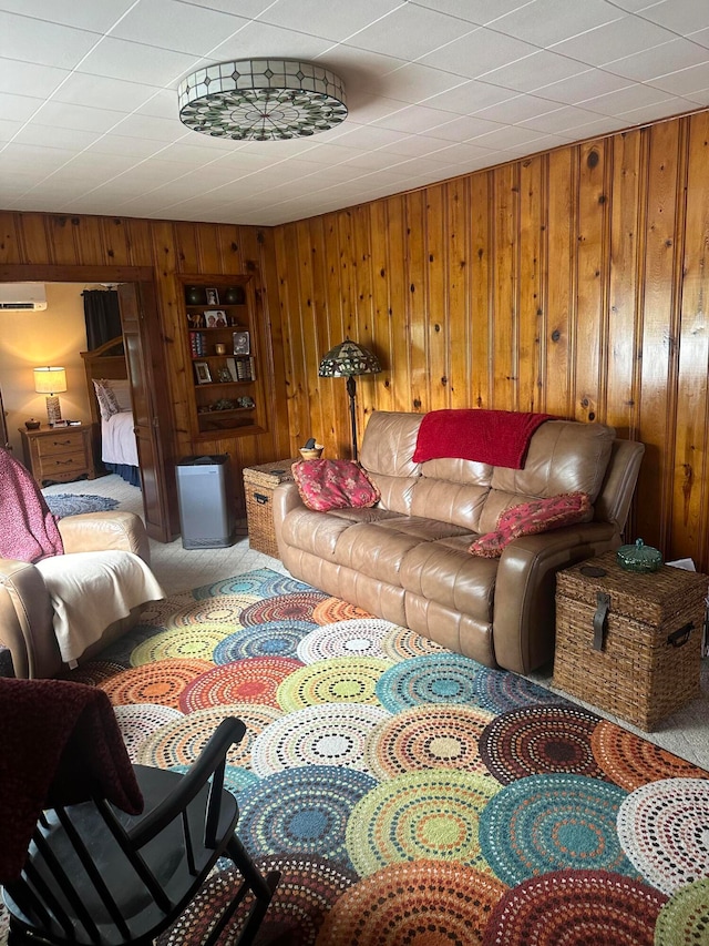 living room featuring a wall mounted air conditioner, wooden walls, and carpet