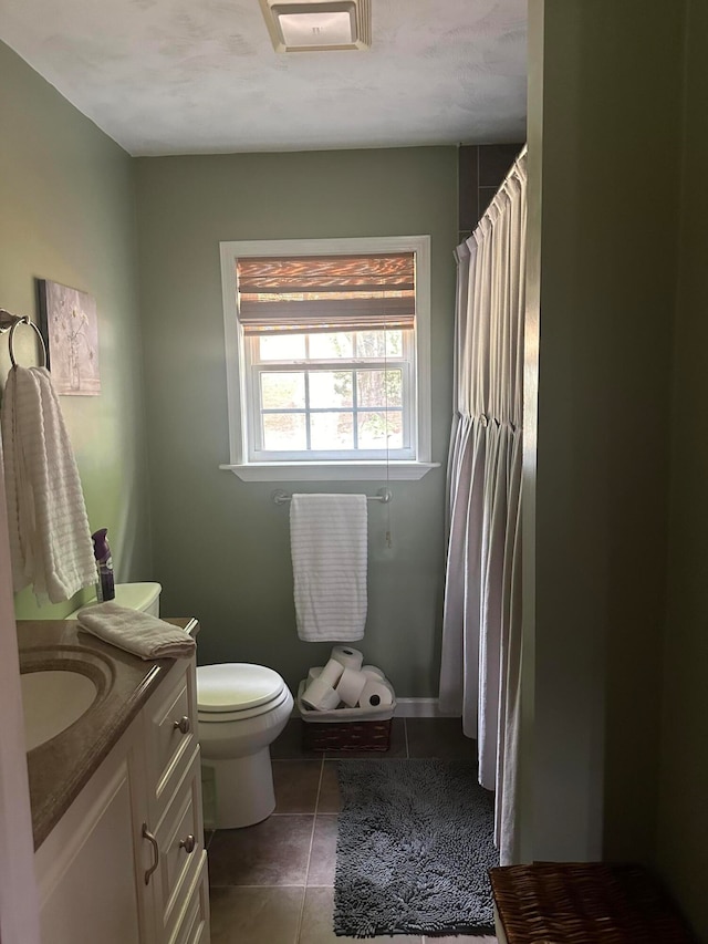 bathroom featuring vanity, toilet, and tile patterned floors