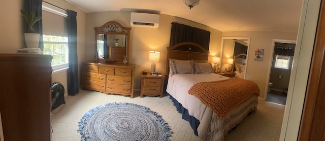 bedroom with light carpet, vaulted ceiling, and a wall unit AC