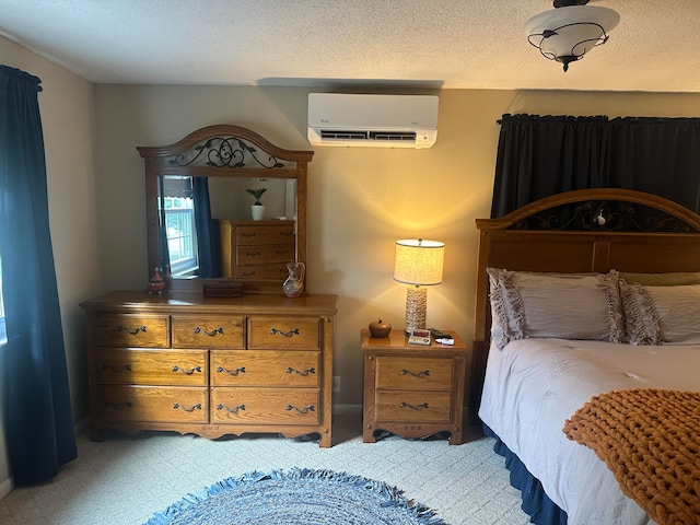 carpeted bedroom featuring a textured ceiling and a wall mounted air conditioner