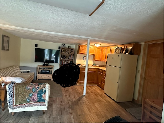 living room featuring a textured ceiling and hardwood / wood-style flooring