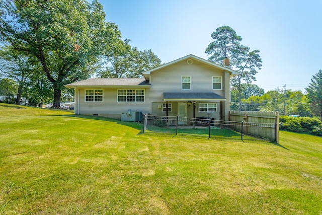 back of house featuring a lawn and central AC unit