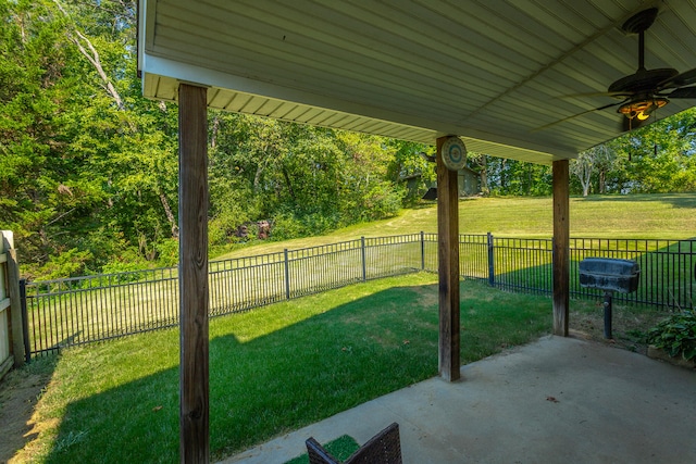 view of yard with ceiling fan and a patio area