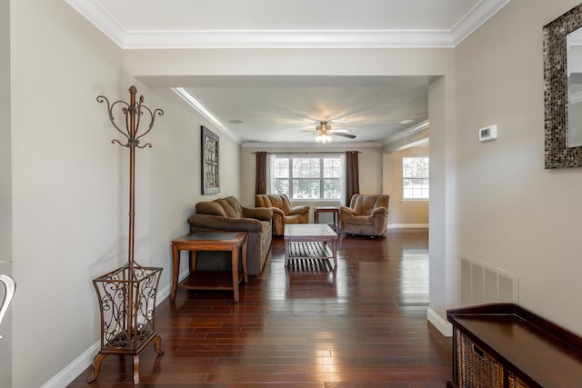 living room with ornamental molding, dark wood-type flooring, and ceiling fan