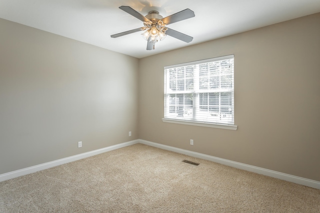 empty room with light colored carpet and ceiling fan