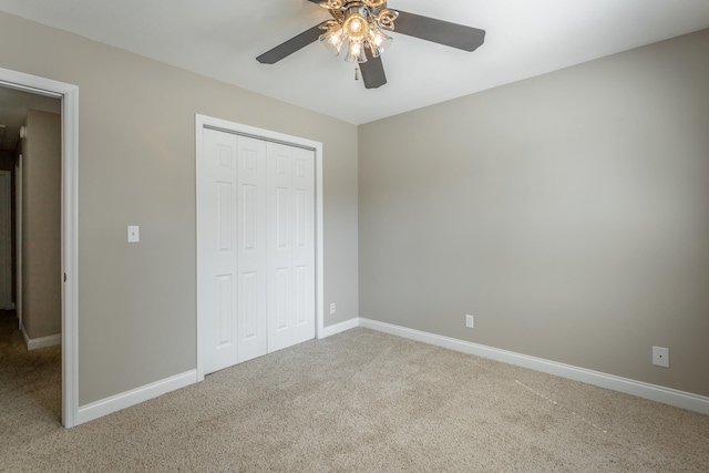 unfurnished bedroom featuring ceiling fan, a closet, and carpet floors