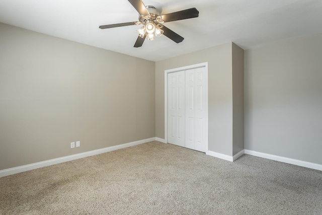 unfurnished bedroom with carpet, ceiling fan, and a closet