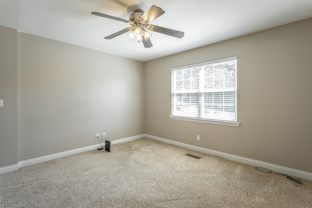 empty room with ceiling fan and carpet floors