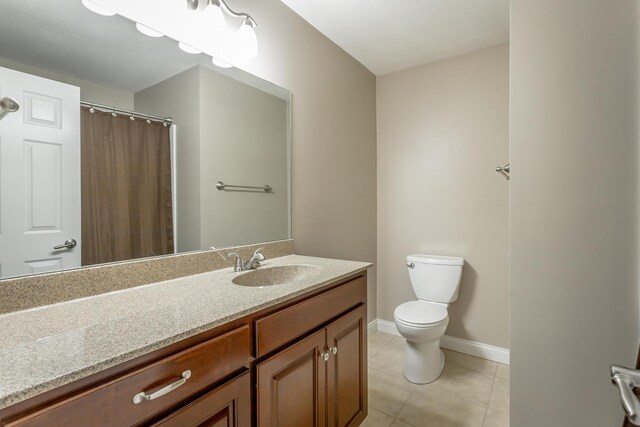 bathroom featuring vanity, toilet, and tile patterned flooring