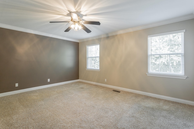 carpeted spare room with ceiling fan and crown molding