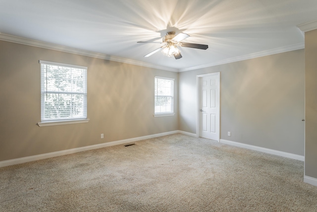 carpeted spare room with crown molding and ceiling fan