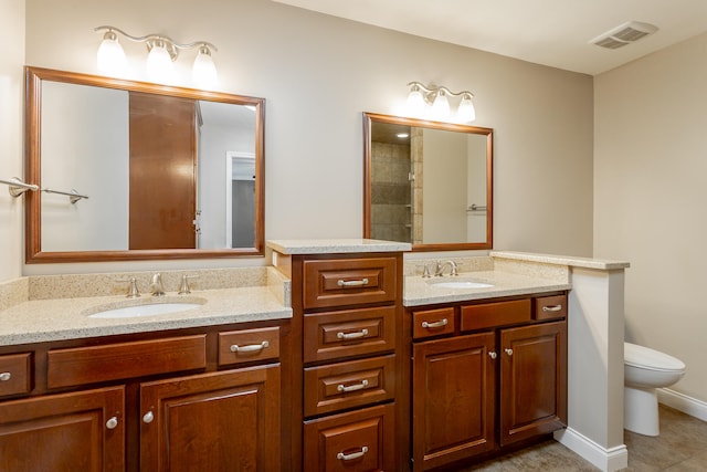 bathroom with vanity, toilet, and tile patterned floors