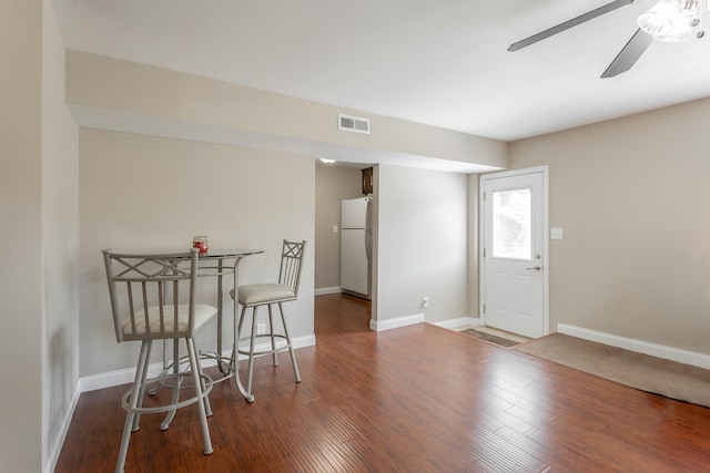 dining area featuring dark wood-type flooring and ceiling fan