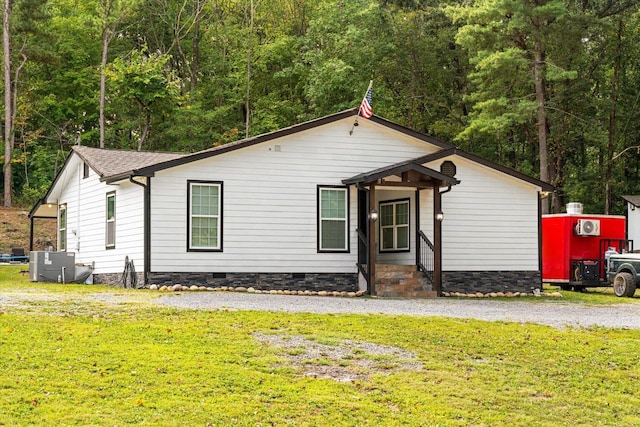 view of front of home featuring a front yard and central air condition unit