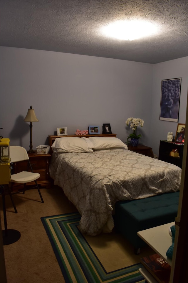 bedroom featuring a textured ceiling and carpet